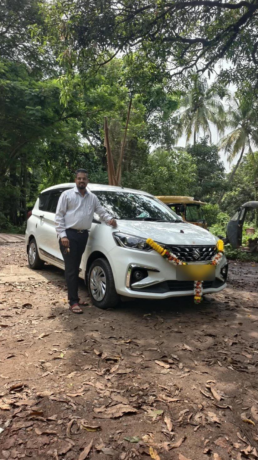 Nayanish with his garlanded Ertiga