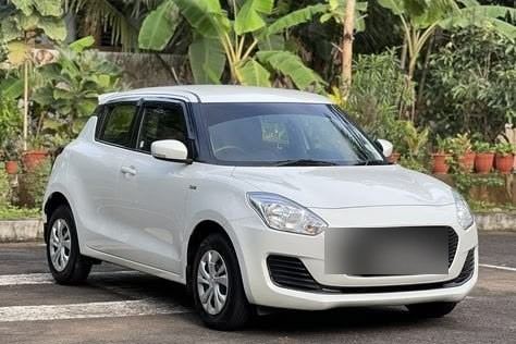 Nayanish's white Maruti Suzuki Swift, front view